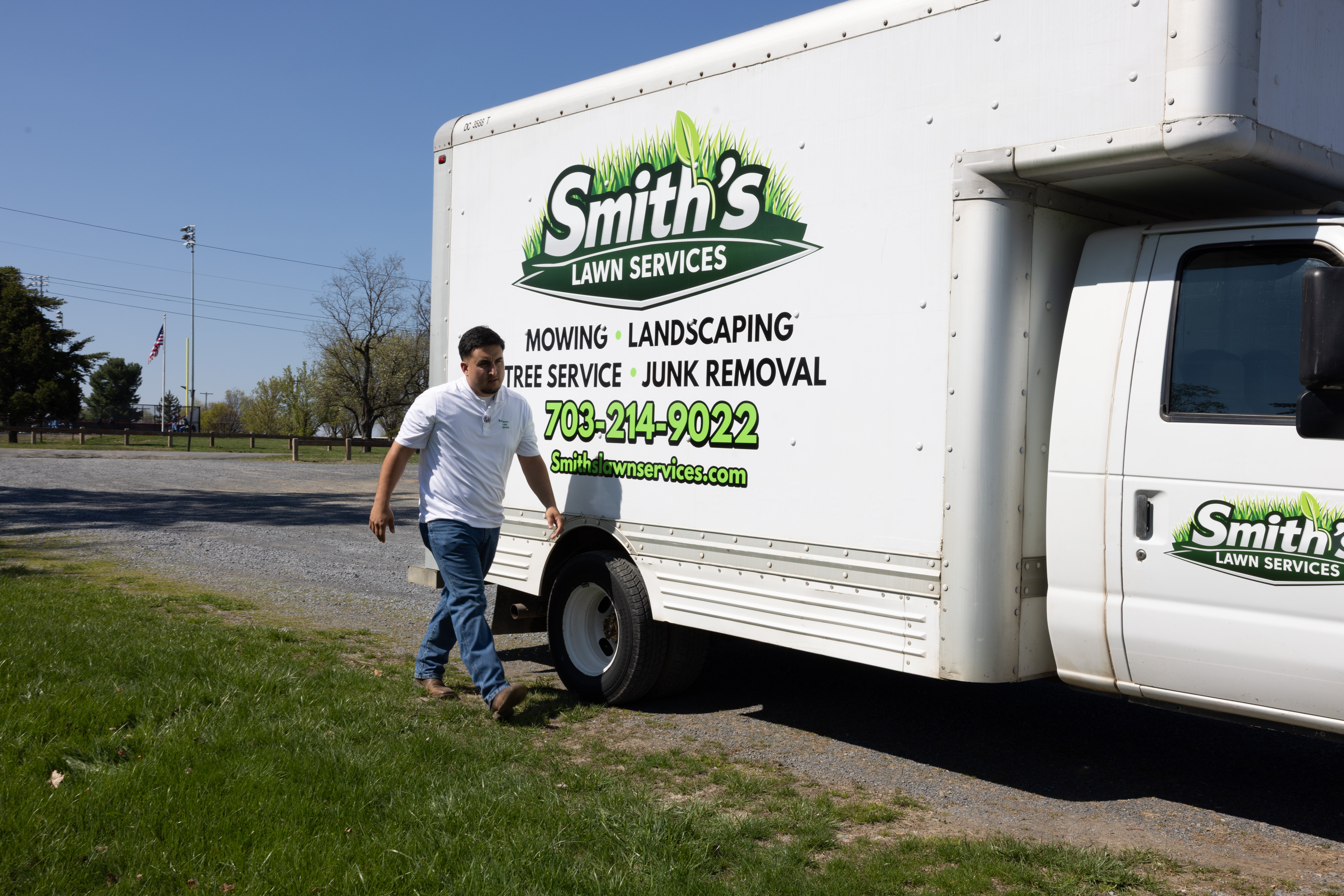 Smith's Lawn Services owner walking by the company truck